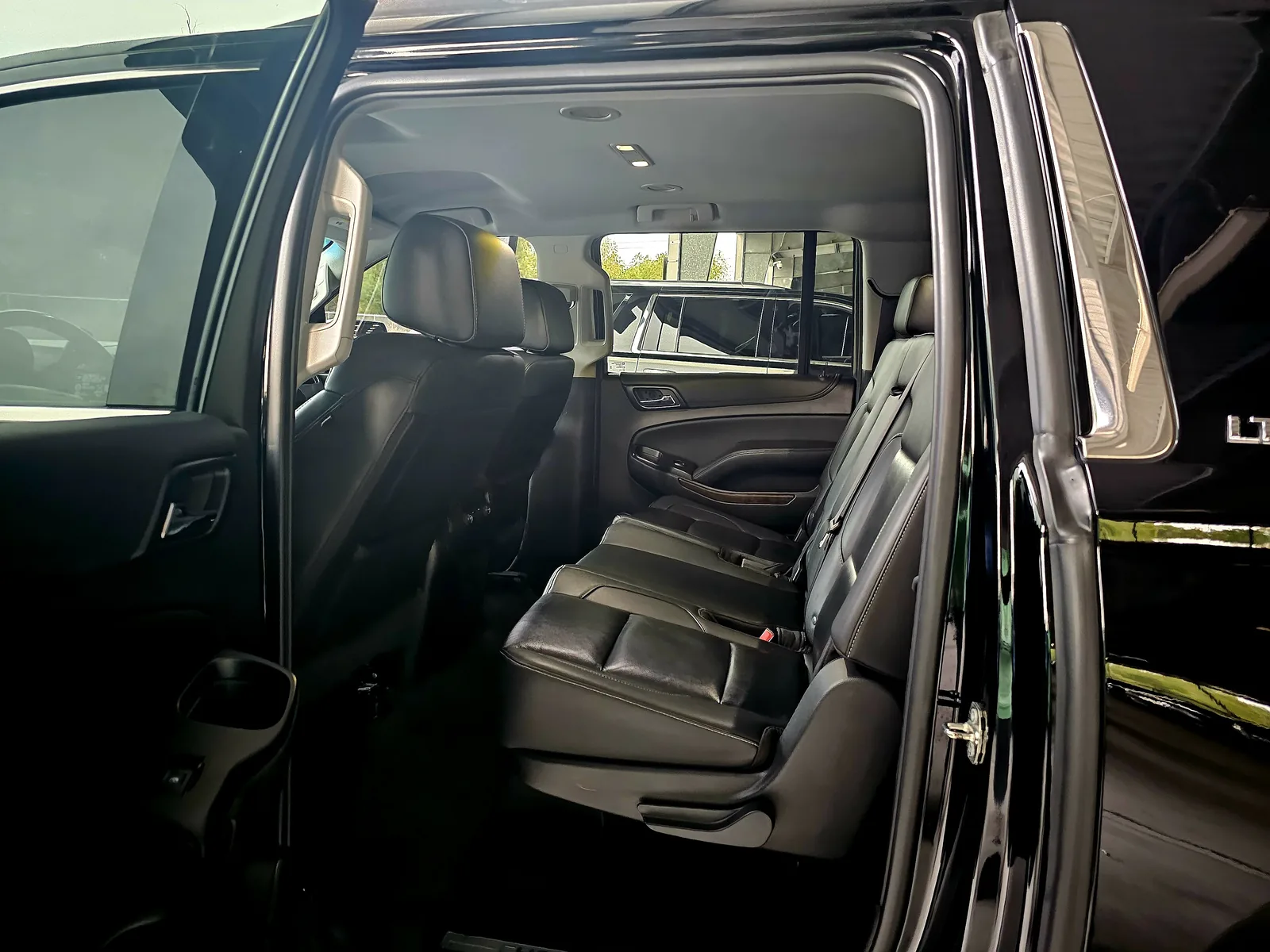 Leather rear bench seating inside the black Suburban private shuttle