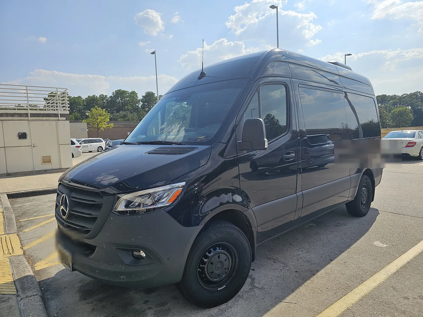 Driver side view of the 14-seat Mercedes Sprinter Galveston cruise shuttle