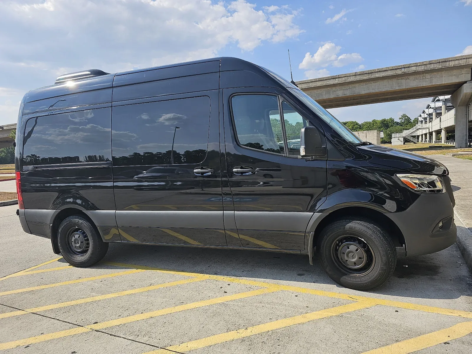 Black Mercedes-Benz Sprinter van used for Houston to Galveston cruise transfers, side profile